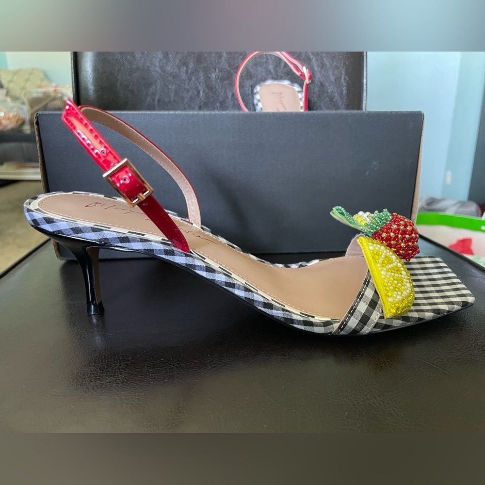 Colson is a kitten heel sandal w/ a slingback strap and fruit embellishments.